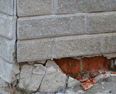 Crumbling concrete on the outside of a foundation
