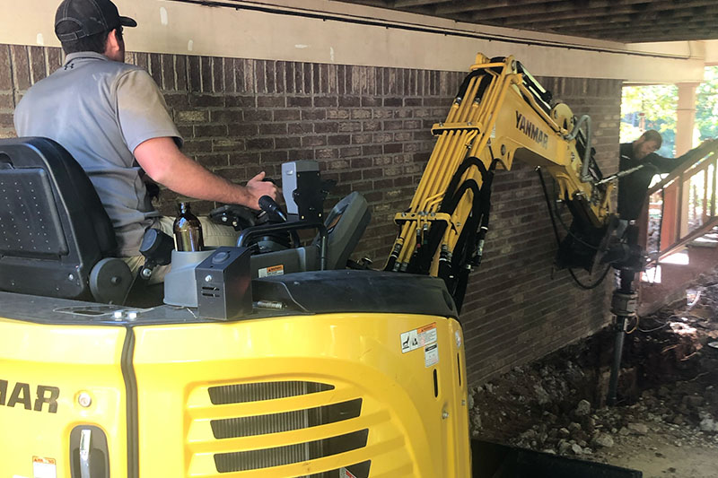 excavator at house