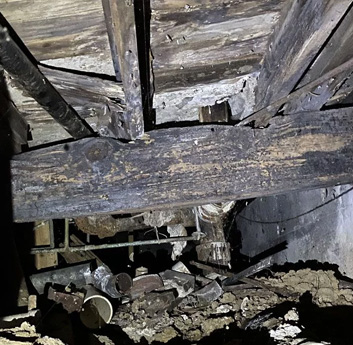 viewing rotted floor joists from within a crawl space